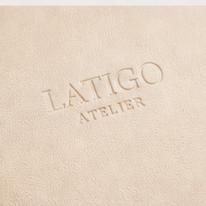 Embossed Latigo Atelier mark on ivory cream vegan leather