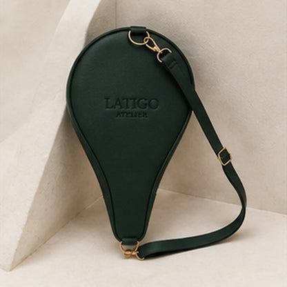 Forest green padel cover standing against a wall